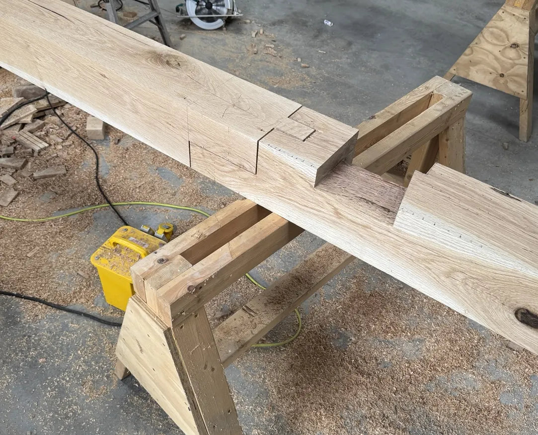 Traditional scarf joint cut into an oak beam in the workshop